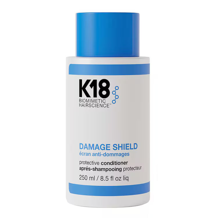 Flacon d’après-shampooing protecteur K18 Damage Shield, 250 ml, avec bouchon bleu, présenté de face sur fond blanc.