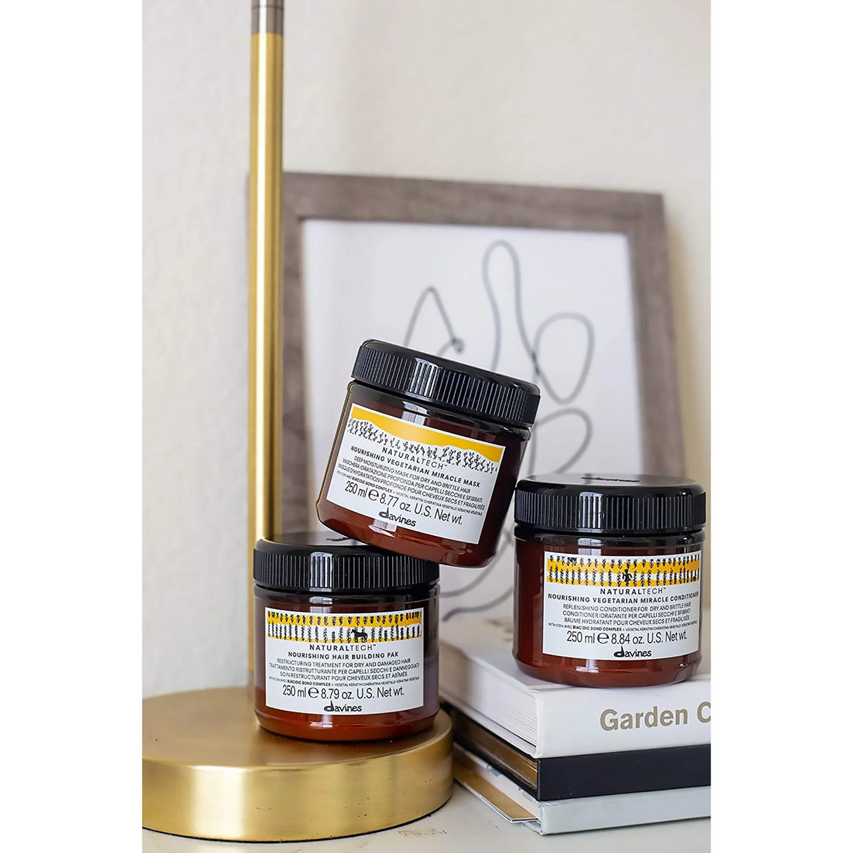Davines Naturaltech Nourishing – masque, Hair Building Pak et conditionneur 250 ml présentés sur des livres