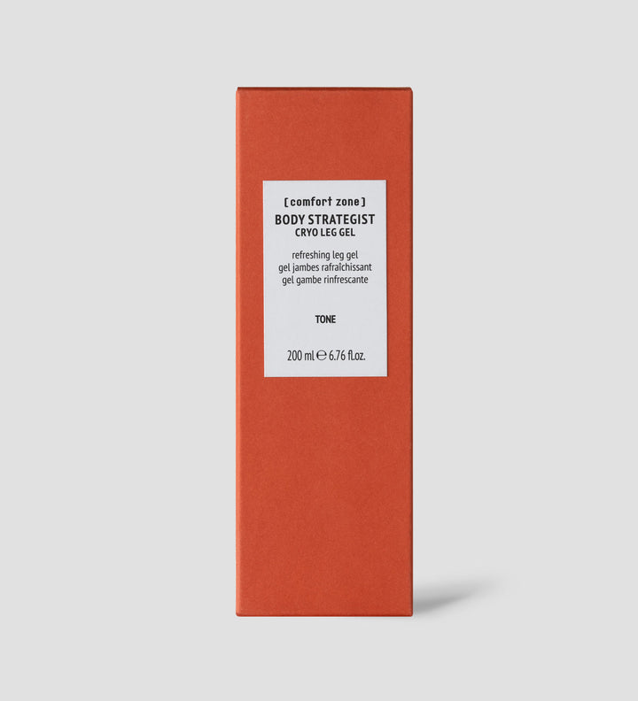 Boîte de "Body Strategist Cryo Leg Gel" de Comfort Zone, affichée sur un fond gris clair. Cette boîte orange contient un gel rafraîchissant pour les jambes, avec des étiquettes en anglais, français et italien indiquant ses propriétés tonifiantes et rafraîchissantes. Contenance : 200 ml.