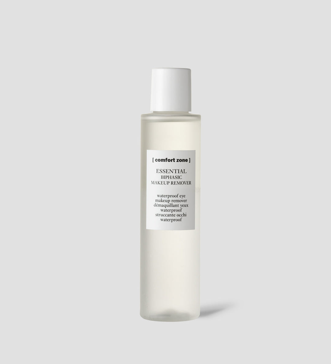 Flacon de Comfort Zone Essential Biphasic Makeup Remover, démaquillant yeux waterproof, sur fond gris clair. Flacon transparent avec un bouchon blanc.