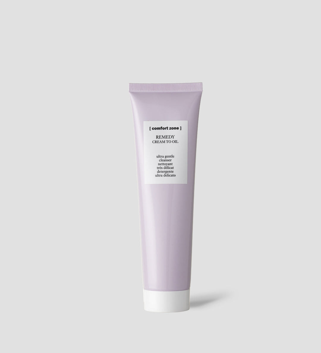 Produit de soin Comfort Zone Remedy Cream to Oil dans un tube violet clair avec un bouchon blanc. Le texte sur le tube indique qu'il s'agit d'un nettoyant ultra-doux.
