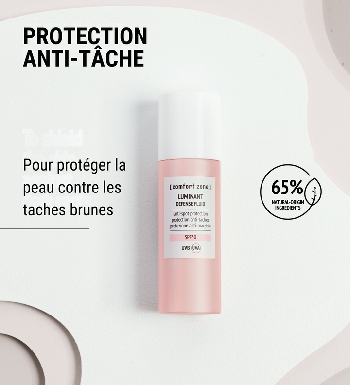 Le Luminant Defense Fluid de Comfort Zone présenté sur un fond clair, avec une mention de 65% d'ingrédients d'origine naturelle. Le produit offre une protection anti-tâche pour protéger la peau contre les taches brunes. Un soin efficace pour un teint uniforme et protégé.