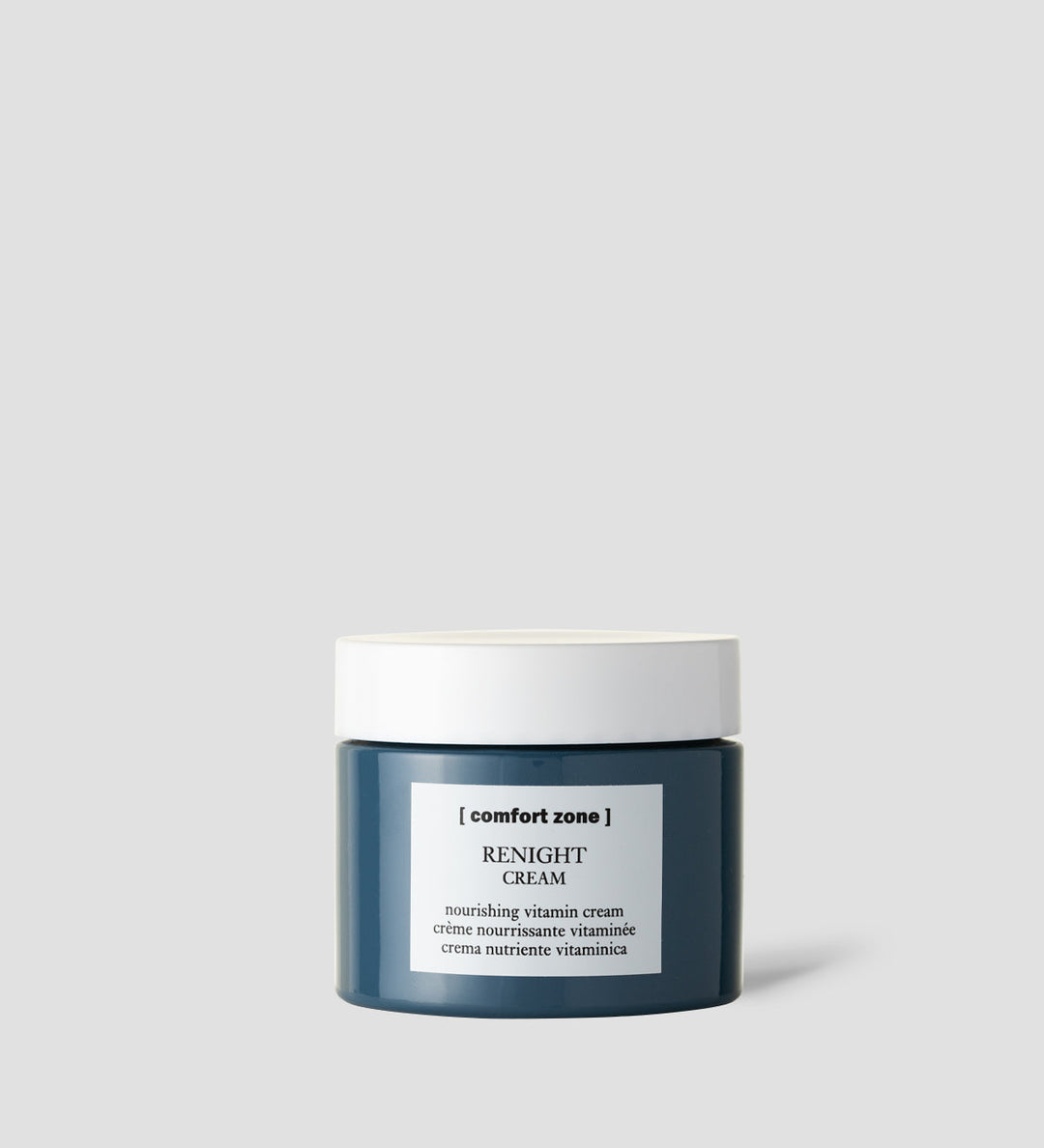 Pot de crème Renight de Comfort Zone sur un fond gris clair. Le pot est bleu foncé avec un couvercle blanc et une étiquette blanche indiquant "Renight Cream".