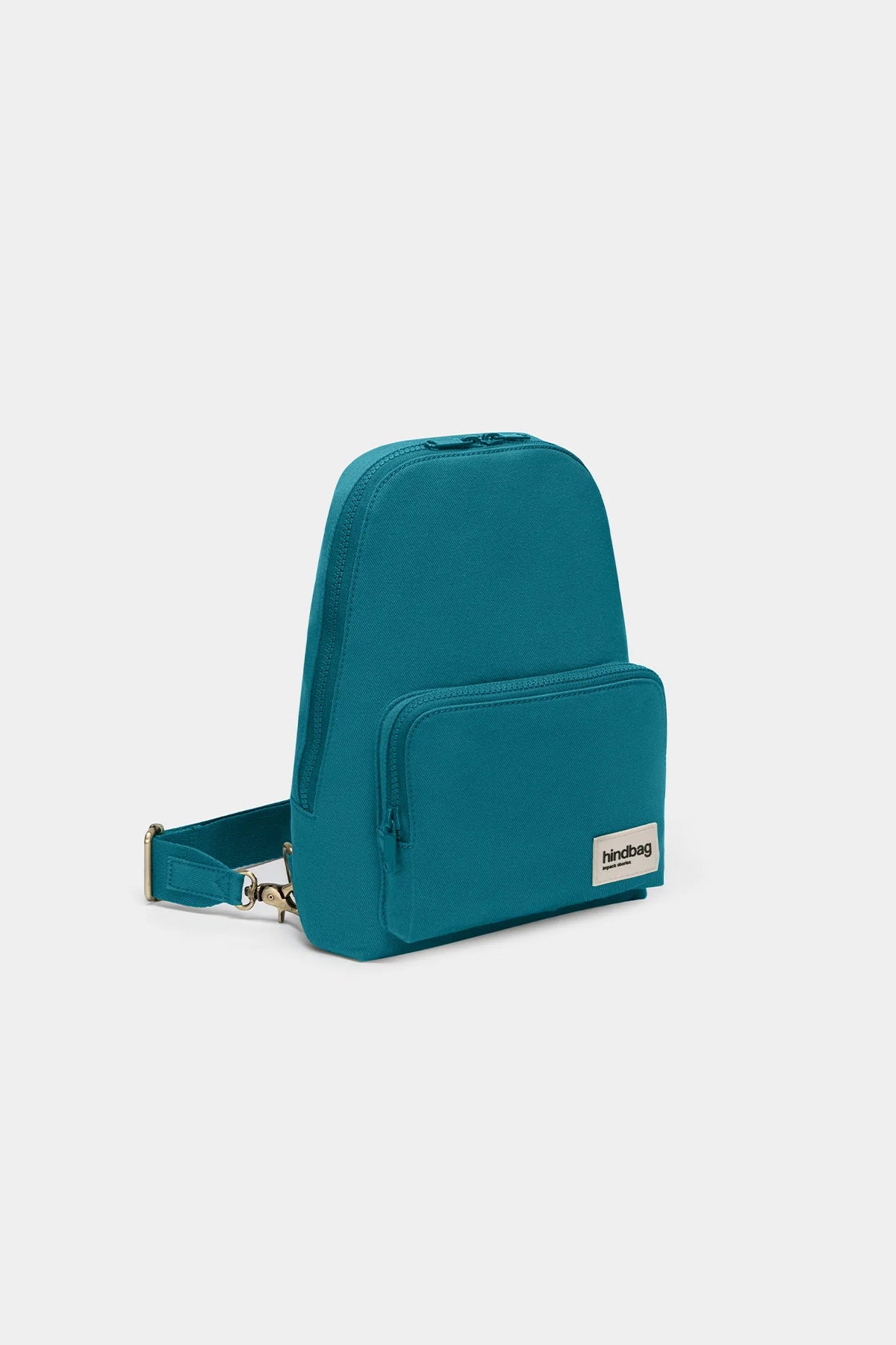 Vue de côté du Hindbag Sling Bag Felix Bleu Paon, sac bandoulière compact et minimaliste en coton épais signé Hindbag