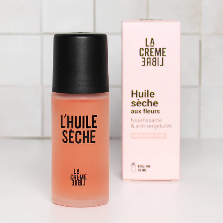 Bouteille de L'Huile Sèche La Crème Libre avec son emballage en arrière-plan.